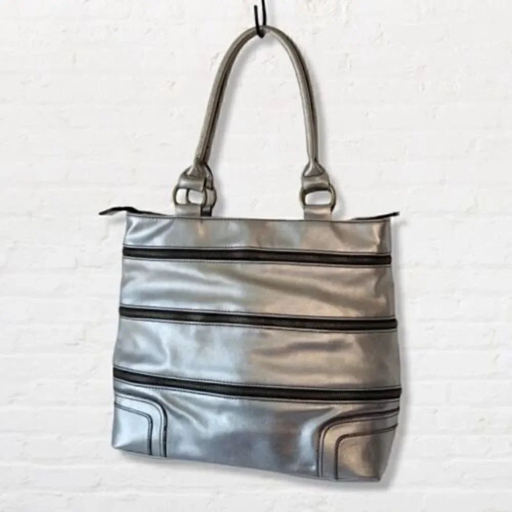 Silver Tote Shoulder Bag with Three Wrap Around Zippers the Open to Expand 3"